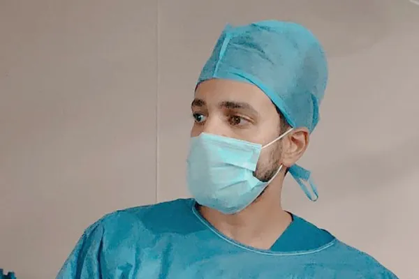 In surgical cap and mask before a procedure