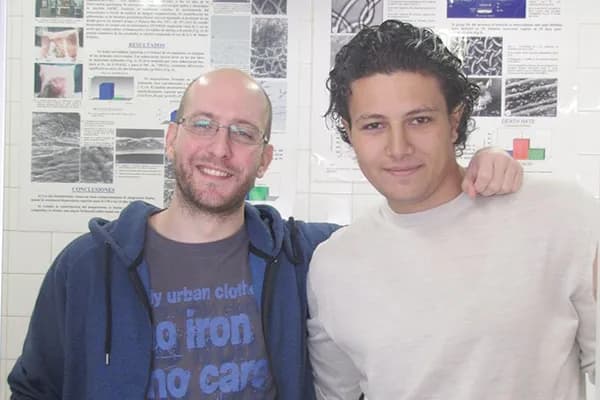 With a colleague in front of a research poster